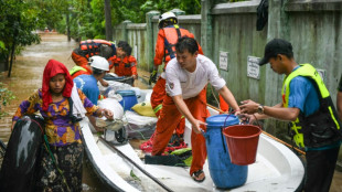 Myanmar residents flee deadly floods in boats and on makeshift rafts