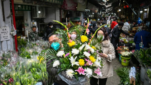 Bustling Wuhan markets celebrate New Year but grief remains